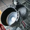 An air fryer basket is placed in a dishwasher rack. Produktbild-Vorschau