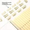 A collection of cream-colored pleats and accessories for a window blind, arranged on a white background. Produktbild-Vorschau