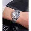 A person wearing a watch on their wrist, with a black leather jacket in the background. Náhled obrázku produktu