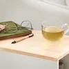 A desk with a cup of tea, glasses, and a pen on a notebook. Náhľad obrázku produktu
