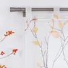 A close-up view of a window with a curtain rod and a transparent curtain with a leaf pattern. Produktbild-Vorschau