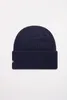 A navy blue beanie hat is shown against a white background. Podgląd zdjęcia produktu