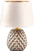 A table lamp with a textured ceramic base and a fabric lampshade. Anteprima dell’immagine prodotto