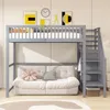 A loft bed with a sofa underneath, decorated with pillows and artwork on the wall. Produktbild-Vorschau