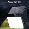 A solar-powered outdoor light with a solar panel, shown in the rain. Produktbild-Vorschau