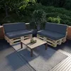 Outdoor patio furniture set on a deck with greenery in the background. Produktbild-Vorschau
