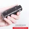 A hand holding a black object under running water. Produktbild-Vorschau