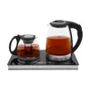 A glass electric kettle and a glass teapot are placed on a black heating base. Podgląd zdjęcia produktu