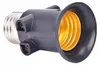 A close-up product shot of a black and gold light bulb socket adapter on a white background. Náhľad obrázku produktu