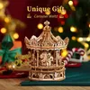 A wooden carousel model is displayed in a festive, Christmas-themed setting with blurred lights and decorations in the background. Anteprima dell’immagine prodotto