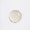 A single drop of clear liquid on a white textured background. Anteprima dell’immagine prodotto