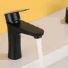 A black faucet with water running into a sink. Náhľad obrázku produktu
