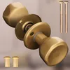 A set of brass door knobs and mounting hardware. Produktbild-Vorschau