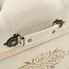 A close-up view of a storage bench's handle and decorative element. Podgląd zdjęcia produktu