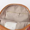 Interior view of a backpack, showing a zippered pocket and a name tag. Anteprima dell’immagine prodotto
