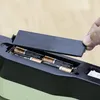 A hand is shown placing batteries into a battery compartment of a product. Podgląd zdjęcia produktu