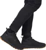 A person wearing black jeans and black high-top boots. Produktbild-Vorschau