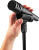 A hand holding a black microphone attached to a stand. Anteprima dell’immagine prodotto