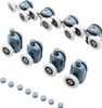 A set of shower door rollers and small circular caps arranged on a white background. Náhľad obrázku produktu