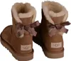 A pair of brown UGG boots with bows on the back. Produktbild-Vorschau