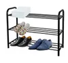 A three-tier black metal shoe rack with various shoes and a white box on it. Náhľad obrázku produktu