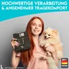 A woman holds a dog diaper and a small dog, with marketing text overlayed on the image. Produktbild-Vorschau
