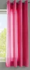 A close-up view of pink curtains hanging in front of a window. Produktbild-Vorschau