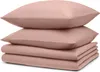 A stack of folded bedding and pillows. Voir les images du produit