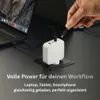 A hand is plugging a USB-C cable into a white multi-port charger, which is connected to a laptop. The charger is placed on a black stand on a dark desk. Produktbild-Vorschau