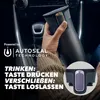A person's hand holding a travel mug inside a car. Produktbild-Vorschau