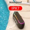 A portable speaker is placed on a poolside surface with water splashing around it. Produktbild-Vorschau