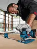 A man is using a jigsaw to cut a piece of wood in what appears to be a workshop or construction site with large windows. Produktbild-Vorschau