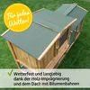 A wooden rabbit hutch with a green roof, placed on grass. Produktbild-Vorschau
