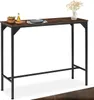 A high bar table with a dark wood top and black metal legs, set against a white background. Small decorative items are placed on the table. Náhled obrázku produktu