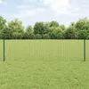 A green wire mesh fence with metal posts stands in a grassy field, with a line of trees and a cloudy sky in the background. Podgląd zdjęcia produktu
