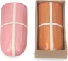 Two ceramic humidifiers, one pink and one orange, are shown against a white background. The orange humidifier is in a cardboard box. Produktbild-Vorschau