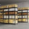 Shelving units filled with boxes and barrels in a storage area. Produktbild-Vorschau