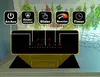 A black induction cooktop with illuminated controls and feature icons above it, set against a background of hanging dried herbs. Produktbild-Vorschau