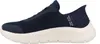 A side view of a navy blue Skechers slip-on sneaker with a cream-colored sole. Anteprima dell’immagine prodotto