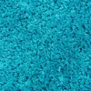 A close-up view of a turquoise shaggy rug. Produktbild-Vorschau