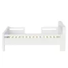 A white wooden bed frame with a slatted base and side rails, shown from the side against a white background. Produktbild-Vorschau