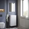 A modern bathroom with a wall-mounted vanity, toilet, and window. Anteprima dell’immagine prodotto