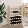 A wooden wine rack filled with wine bottles, placed next to a large potted plant. Podgląd zdjęcia produktu