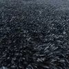A close-up view of a dark gray shaggy carpet. Produktbild-Vorschau