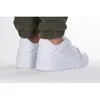A person wearing white Puma sneakers and green pants. Produktbild-Vorschau
