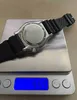 A watch is placed on a digital scale. Produktbild-Vorschau