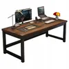 A modern computer desk with a dark wood finish and black metal legs, set up with a monitor, laptop, keyboard, and desk lamp. Produktbild-Vorschau