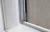 Close-up view of a window screen frame and mesh. Produktbild-Vorschau