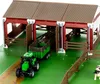 A toy farm set with a tractor and trailer inside a barn. Produktbild-Vorschau