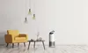 A modern living room scene with a yellow armchair, a coffee table with decorative items, and an air purifier. Anteprima dell’immagine prodotto